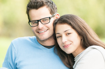 Obraz premium Portrait of happy young man and woman in park.