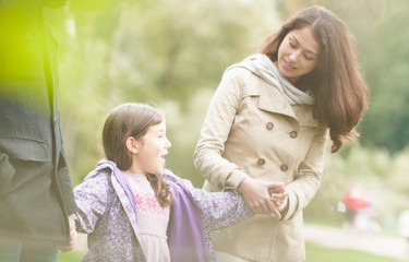 Fototapeta premium Young happy family of three walking outdoor.