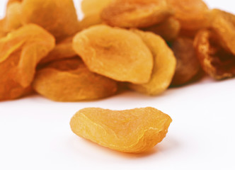 heap of dried apricots isolated on white;