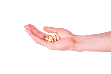 Male hand holding a handful of medical pills