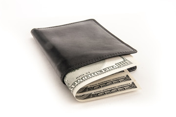 US dollars in a black wallet isolated on white