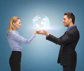 man and woman showing earth globe on the palms