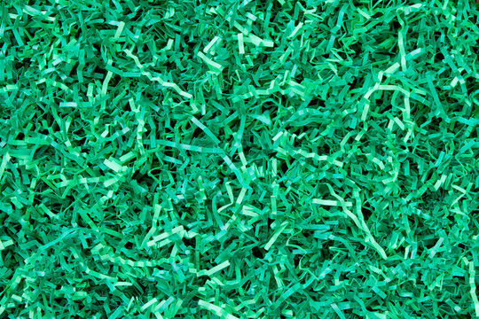 Close-up of green shredded paper packaging material background