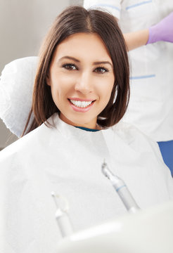 Happy Young Woman Patient at Dentist