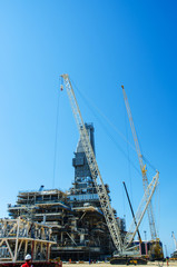 Offshore drilling during construction onshore