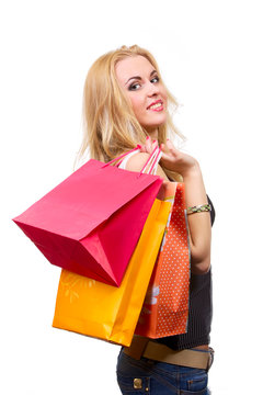 Young smiling woman with shopping bags isolated on white