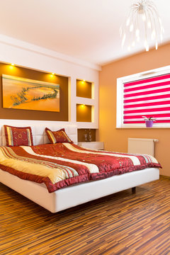 Master bedroom interior with picture of shipwreck on the wall