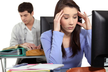Fototapeta premium Student with a headache at a computer