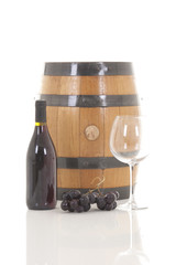Red wine with grapes and barrel