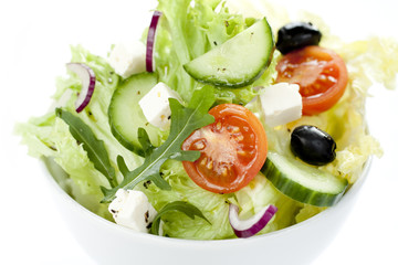Greek salad in a white bowl from above