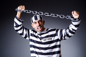 Convict criminal in striped uniform