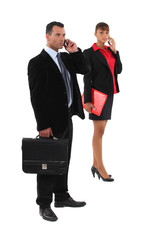 businessman and businesswoman talking on their cells