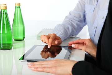 Two businesswomen working with digital tablet