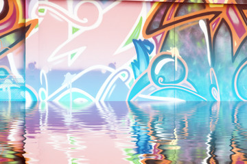 Obraz premium Graffiti wall texture reflection in water, artistic urban pictu