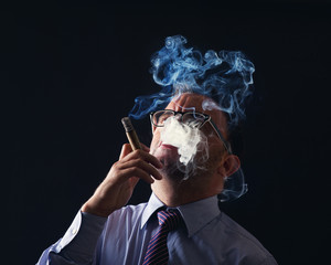 Young Elegant Portrait of a businessman smoking cigar