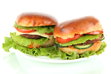 Big and tasty hamburgers on plate isolated on white