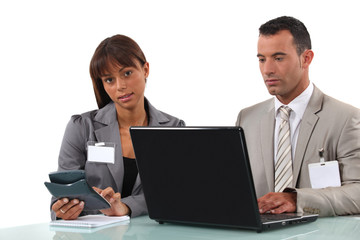 Business couple  with a laptop and calculator