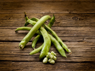 fresh beans broad over wood background