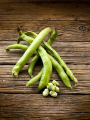 fresh beans broad over wood background