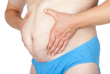 Man grabbing his fat on the stomach