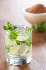 Mojito served in a glass with crushed ice and lime