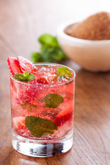 Strawberry mojito served with lime and crushed ice