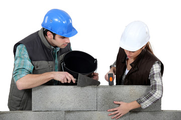 craftsman and craftswoman applying cement