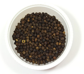 black pepper in a bowl on white background
