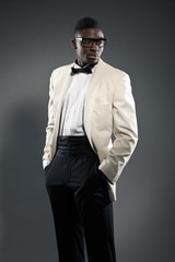Obraz premium Stylish black american man in suit with glasses. Fashion studio
