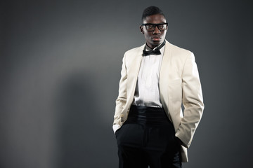 Stylish black american man in suit with glasses. Fashion studio