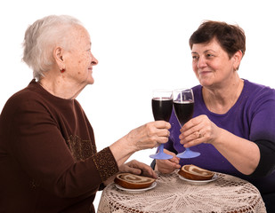 Happy mother with daughter drinking wine