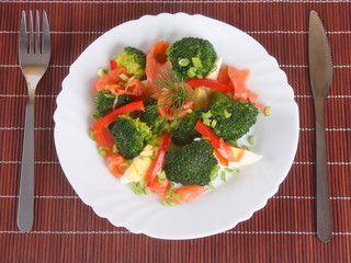 Salad with salmon and broccoli. top view