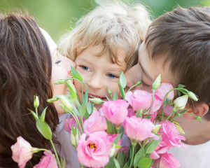 Happy family with bouquet of spring flowers