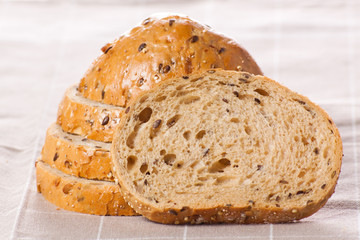 Healthy whole grain sliced bread with sunflower seeds on brown n