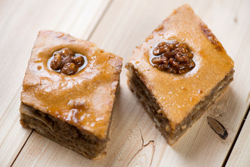 Baklava with walnuts and honey, wooden background