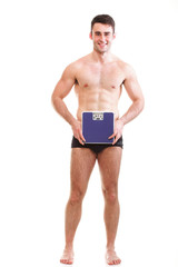 Healthy young man with a weight scale Isolated