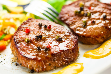 Grilled steak, French fries and vegetables
