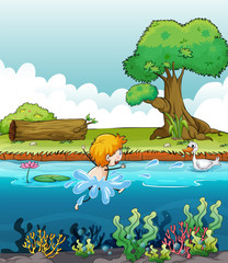 Un garçon nageant avec un canard dans la rivière