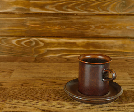 Empty coffee cup on a brown background