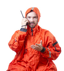 Man in storm cog talking on marine radio