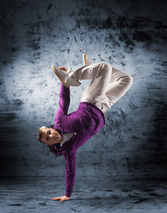 A young and sporty man performing a dance move