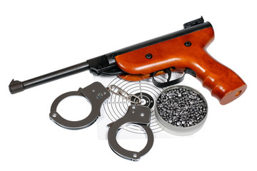 Airgun with handcuffs over white, clipping path