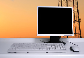PC with sunset sky and electric pylons background