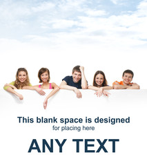 A group of happy teenagers holding a white banner with text