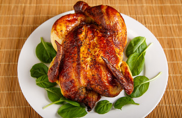 Roast Chicken on Plate Garnished with Spinach Leaves