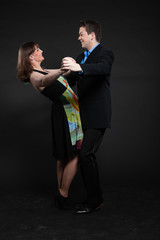 Romantic happy young couple dancing together. Stylish dressed.