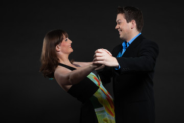 Romantic happy young couple dancing together. Stylish dressed.