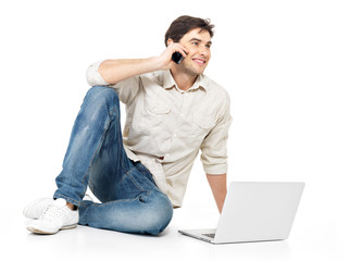 man calling by mobile with laptop