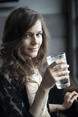 Young Woman Drinking a Pint Glass of Ice Water