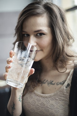 Young Woman Drinking a Pint Glass of Ice Water